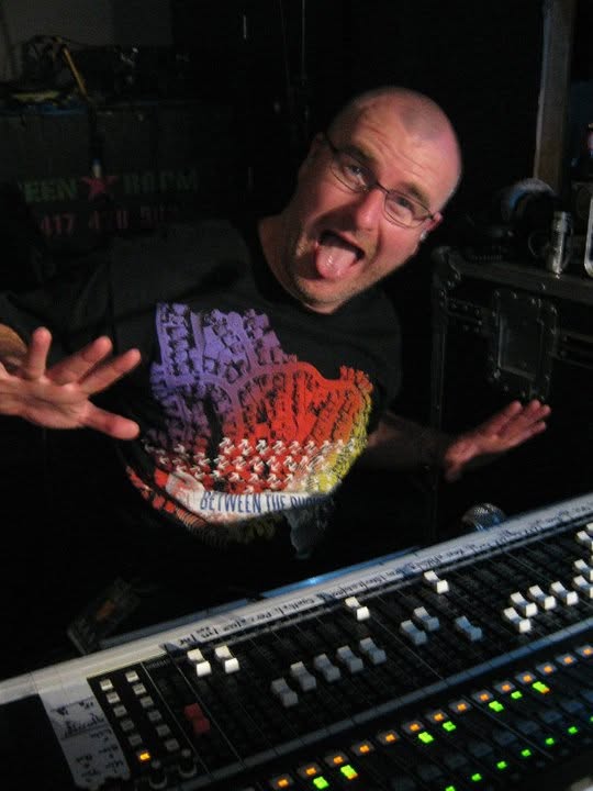 Stuart at a mixing console during a live show, front view